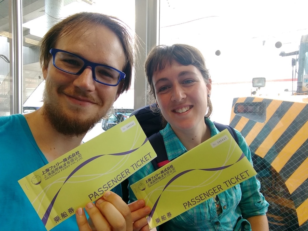 Picture shows Mischa and Rosanna side by side on the ferry. They are each holding their yellow ferry tickets and smiling. 
